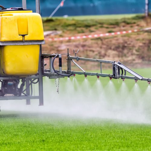 Tractors,Sprayed,With,Fertilizer,Grass,On,The,Pitch Tractors sprayed with fertilizer grass on the pitch